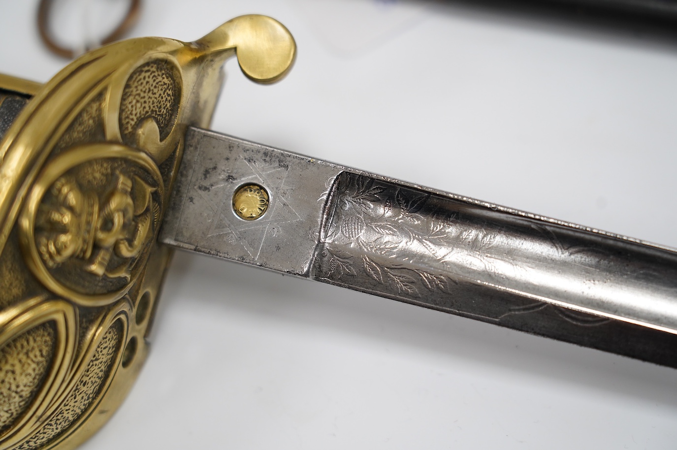 A Victorian warrant officer's sword by Westcott and Sons, regulation brass hilt, black fish skin covered grip, in its brass mounted leather scabbard, blade 79.5cm. Condition - well worn